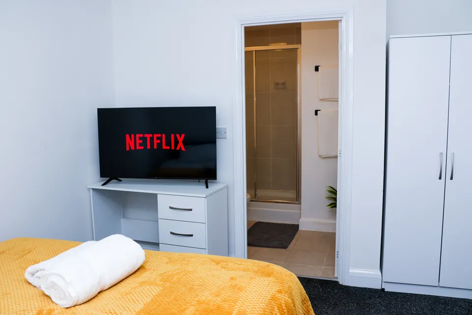 Bedroom at Humber Hub with the door open to its en-suite shower room