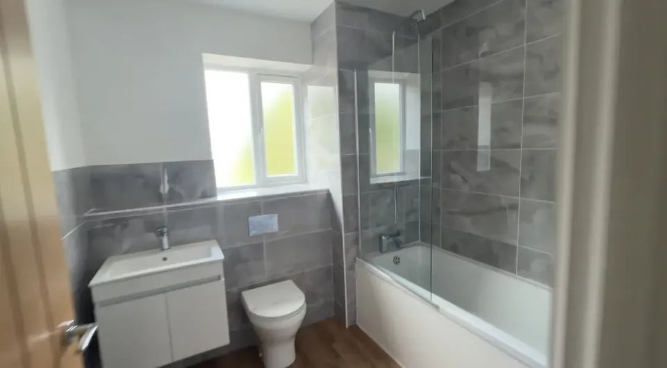 Family bathroom with a bath and shower screen