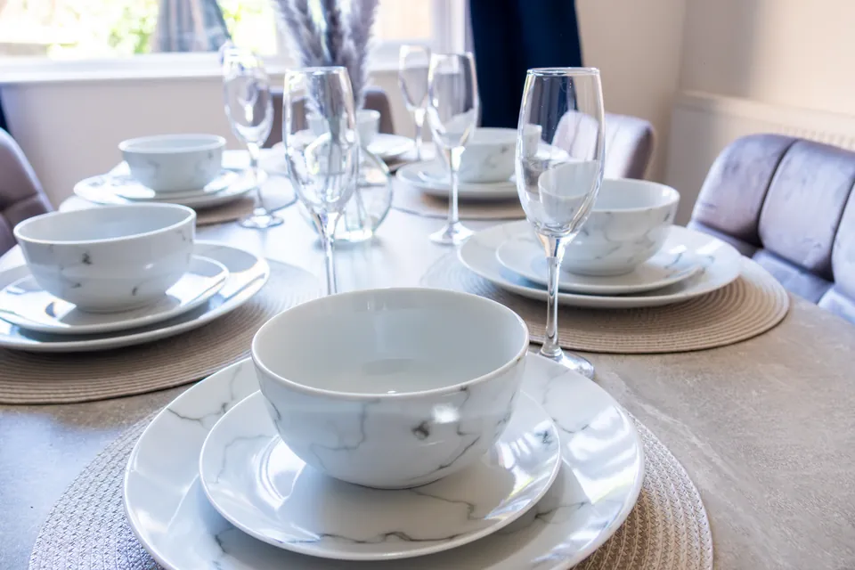 Plates, bowls and glasses laid on the dining table at Sullivan Heights