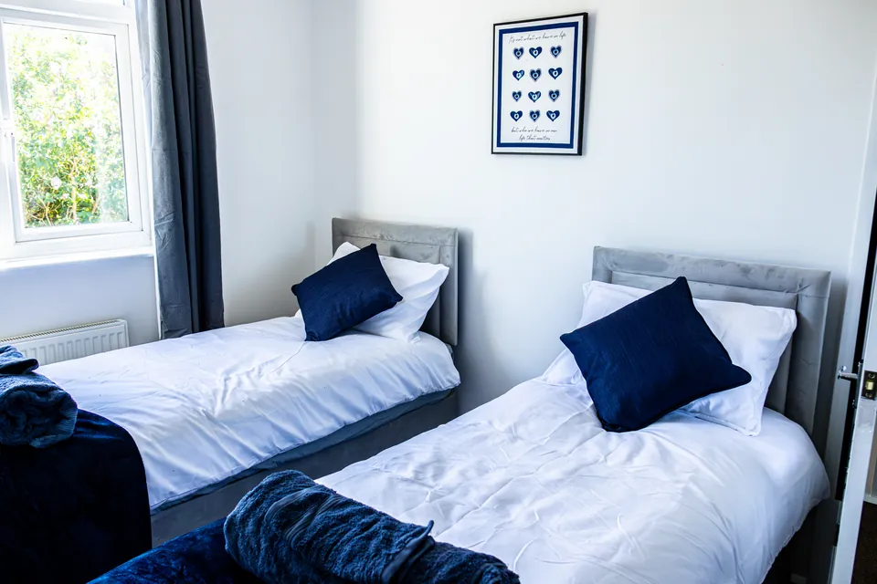 Twin bedroom at Sullivan Heights with navy cushions
